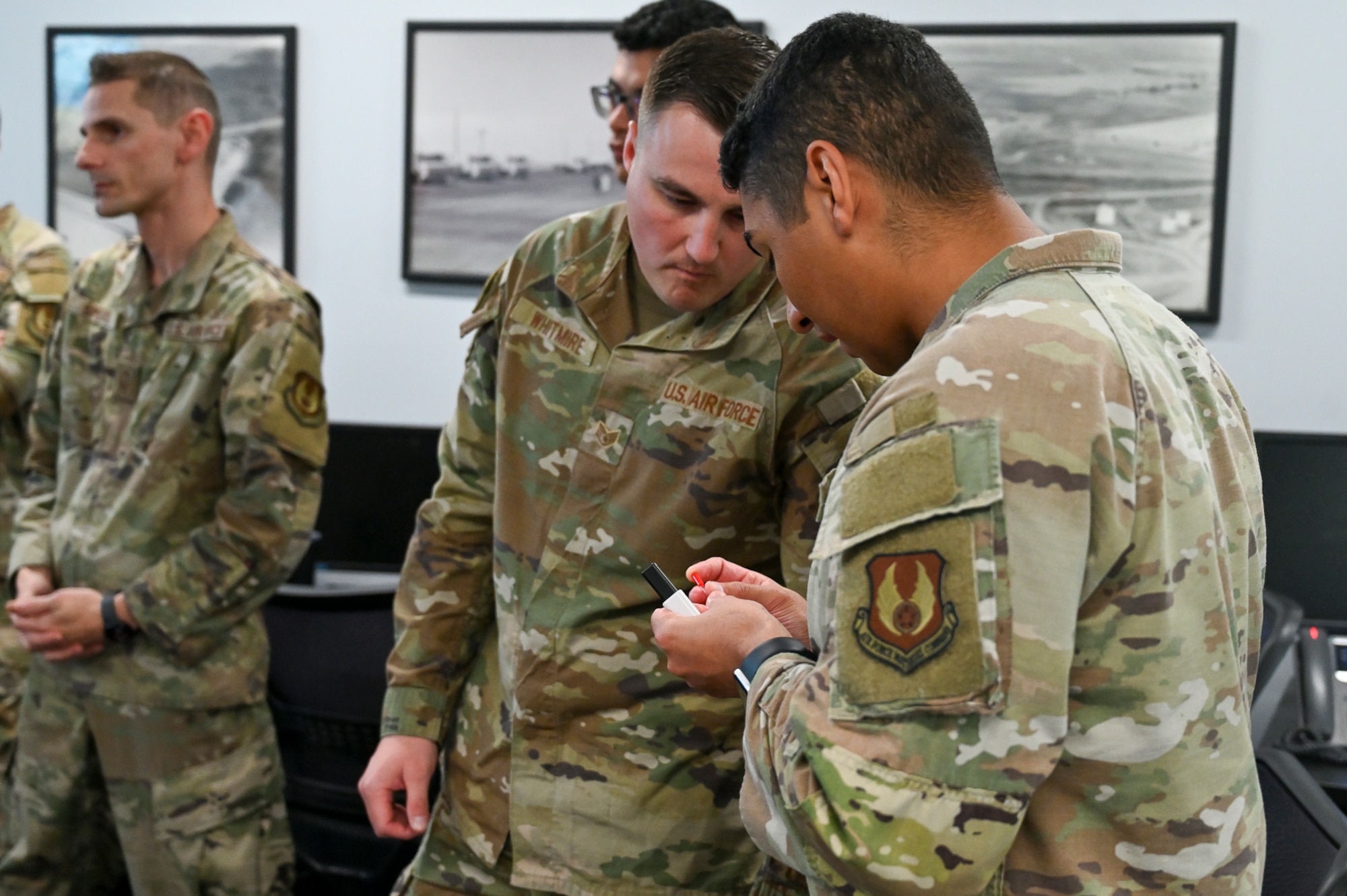 Staff Sgt. Andrew Whitmire, 75th Logistics Readiness Squadron fuels flight, and Capt. Jordan Aritt, 75th LRS fuels management flight commander, examine components of a prototype hydraulic fluid testing device Oct. 27, 2025, at Hill Air Force Base, Utah. The Air Force Petroleum Office, the single enterprise manager for petroleum and aerospace energy, is partnering with the 75th LRS at Hill AFB to develop a prototype that will significantly reduce the time it takes to test jet fuel for contamination from PAO and aviation-grade hydraulic fluid. (U.S. Air Force photo by 1st Lt. Rachel Shaffer)
