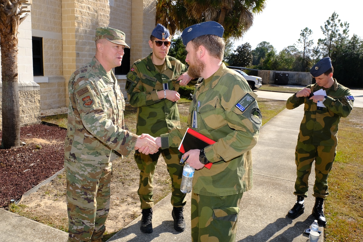 photo US Air Force Airmen and Royal Norwegian Air Force members standing and talking