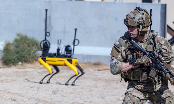 Soldier fights in tandem with various robotics in Human-Machine Integrated Formations during Project Convergence Capstone 5 experiment, March 15, 2025, at Fort Irwin, California.
