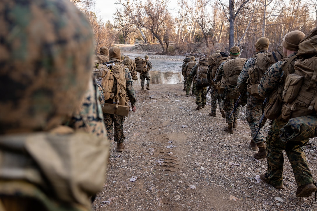 U.S. Marines stop at a river during a Cold Weather Field Exercise at Fort Hunter-Liggett, Calif. on Jan. 10th, 2026. The Marines are a part of Combat Logistics Battalion 23, 4th Marine Logistics Group. CLB-23 conducted a hike to transfer from one training area to another, designed to enhance and test readiness and lethality in the Marine Corps Reserve. (U.S Marine Corps photo by Sgt. Eduardo Delatorre)