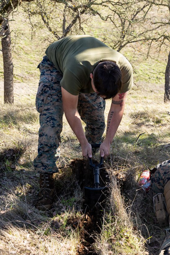 U.S. Marine Corps Lance Cpl. Austin Kaczorowski, a motor vehicle operator, digs a hole during a Cold Weather Field Exercise at Fort Hunter-Liggett, Calif. on Jan. 10th, 2026. Kaczorowski is a part of Combat Logistics Battalion 23, 4th Marine Logistics Group. CLB-23 conducted a hike to transfer from one training area to another, designed to enhance and test readiness and lethality in the Marine Corps Reserve. Kaczorowski is a native of California. (U.S Marine Corps photo by Sgt. Eduardo Delatorre)