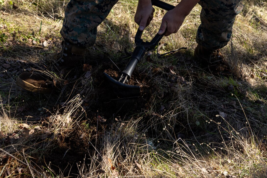 A U.S. Marine digs a hole during a Cold Weather Field Exercise at Fort Hunter-Liggett, Calif. on Jan. 10th, 2026. The Marine is a part of Combat Logistics Battalion 23, 4th Marine Logistics Group. CLB-23 conducted a hike to transfer from one training area to another, designed to enhance and test readiness and lethality in the Marine Corps Reserve. (U.S Marine Corps photo by Sgt. Eduardo Delatorre)