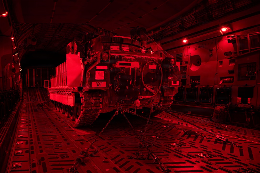 A U.S. Army M2A3 Bradley tank sits on a U.S. Air Force C-17 Globemaster III aircraft as cargo during an airbridge operation in the U.S. Central Command area of responsibility, Nov. 19, 2025. Operating within the CENTCOM AOR, the M2A3 Bradley was designed to transport infantry on the battlefield, provide fire support to dismounted troops and suppress enemy vehicles. (U.S. Air Force photo by Tech. Sgt. Bailee A. Darbasie)