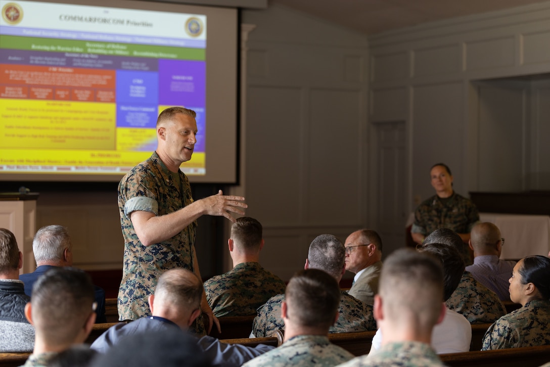 U.S. Navy Cmdr. Jonathan Stephens, the deputy force chaplain with Fleet Marine Force, Atlantic, Marine Forces Command, Marine Forces Northern Command, speaks on upcoming projects and initiatives during a Town Hall meeting at Naval Support Activity Hampton Roads, Norfolk, Virginia, Aug. 15, 2025. The town hall was held to present information previously discussed at an executive off-site regarding future initiatives and topics pertaining to the Marine Corps as a whole (U.S. Marine Corps photo taken by Corporal Catherine S. Verenzuela Mariano)