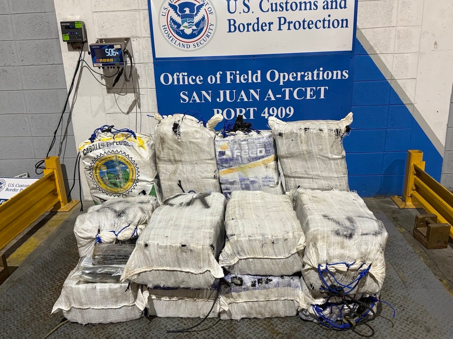 A Coast Guard Station San Juan boat crew and Homeland Security Task Force - San Juan Region partner agencies completed the custody transfer of three apprehended smugglers and the offload of sixteen bales of cocaine which weighed 506kgs/1,115.54 pounds which were valued at more than $7 million.  The apprehension and seizure followed the interdiction of a drug smuggling vessel in Atlantic Ocean waters north of Puerto Rico, Jan. 14, 2026. (U.S. Coast Guard photo)