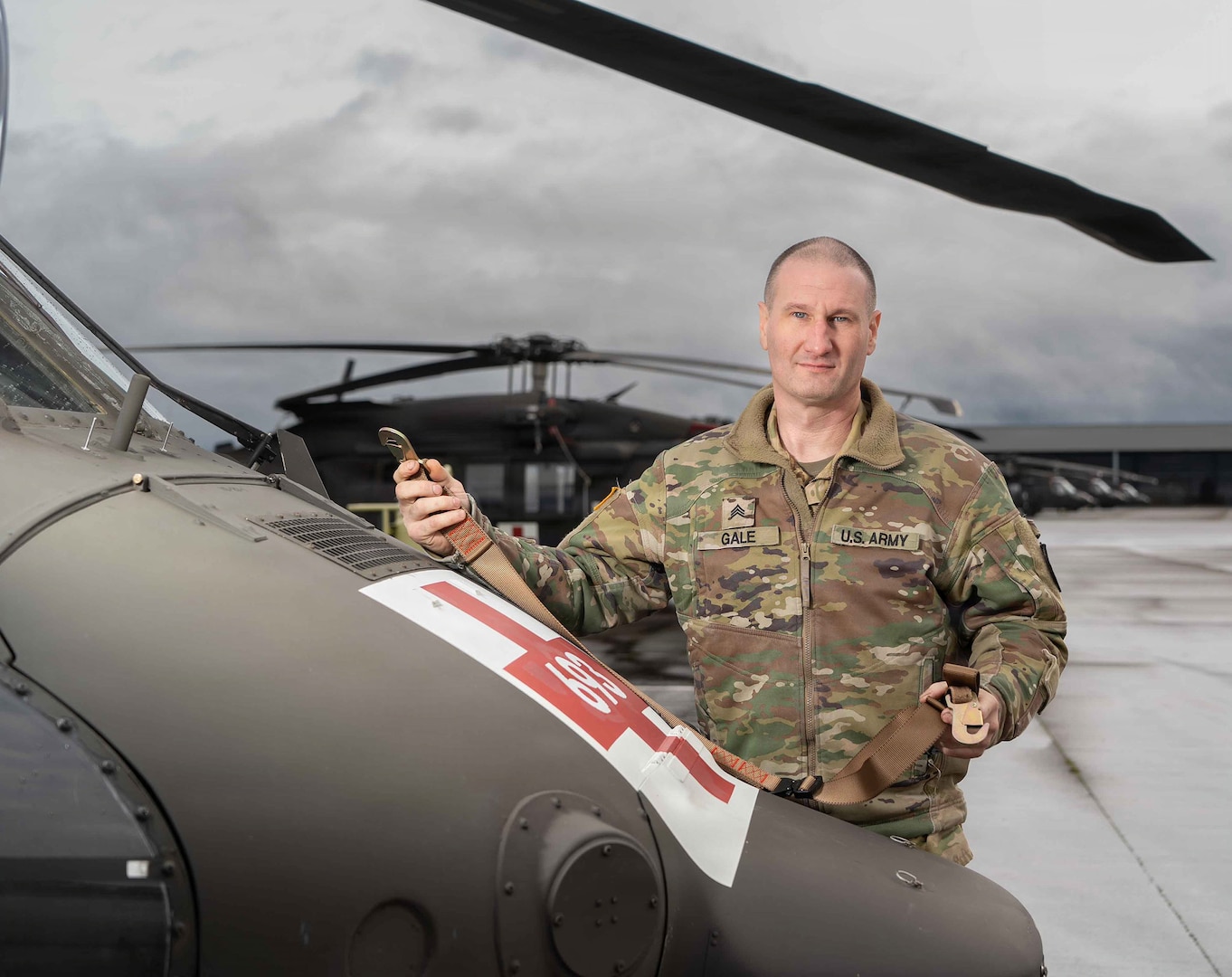 Sgt. James Gale, a crew chief with G Company, 1-189th Aviation, Oregon Army National Guard, displays the SK-1189-V litter strap at Salem's McNary Army National Guard Field Heliport, Dec. 5, 2025.