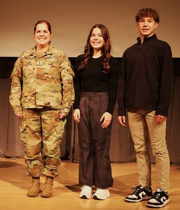 Illinois Army National Guard Chief Warrant Officer 4 Melissa Downey is shown with her 20-year-old daughter, Leah Hiller, and 16-year-old son, Luke Hiller, after her promotion.