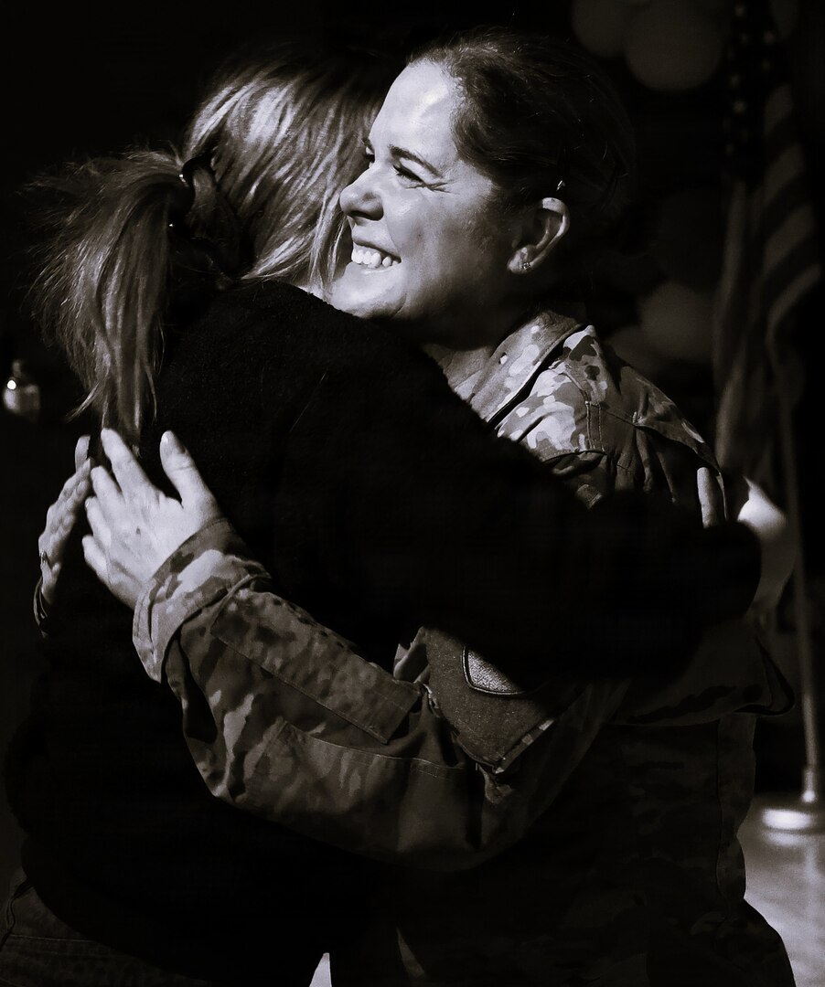 Illinois Army National Guard Chief Warrant Officer 4 Melissa Downey hugs her niece, Kaelan Loftus, after her promotion.