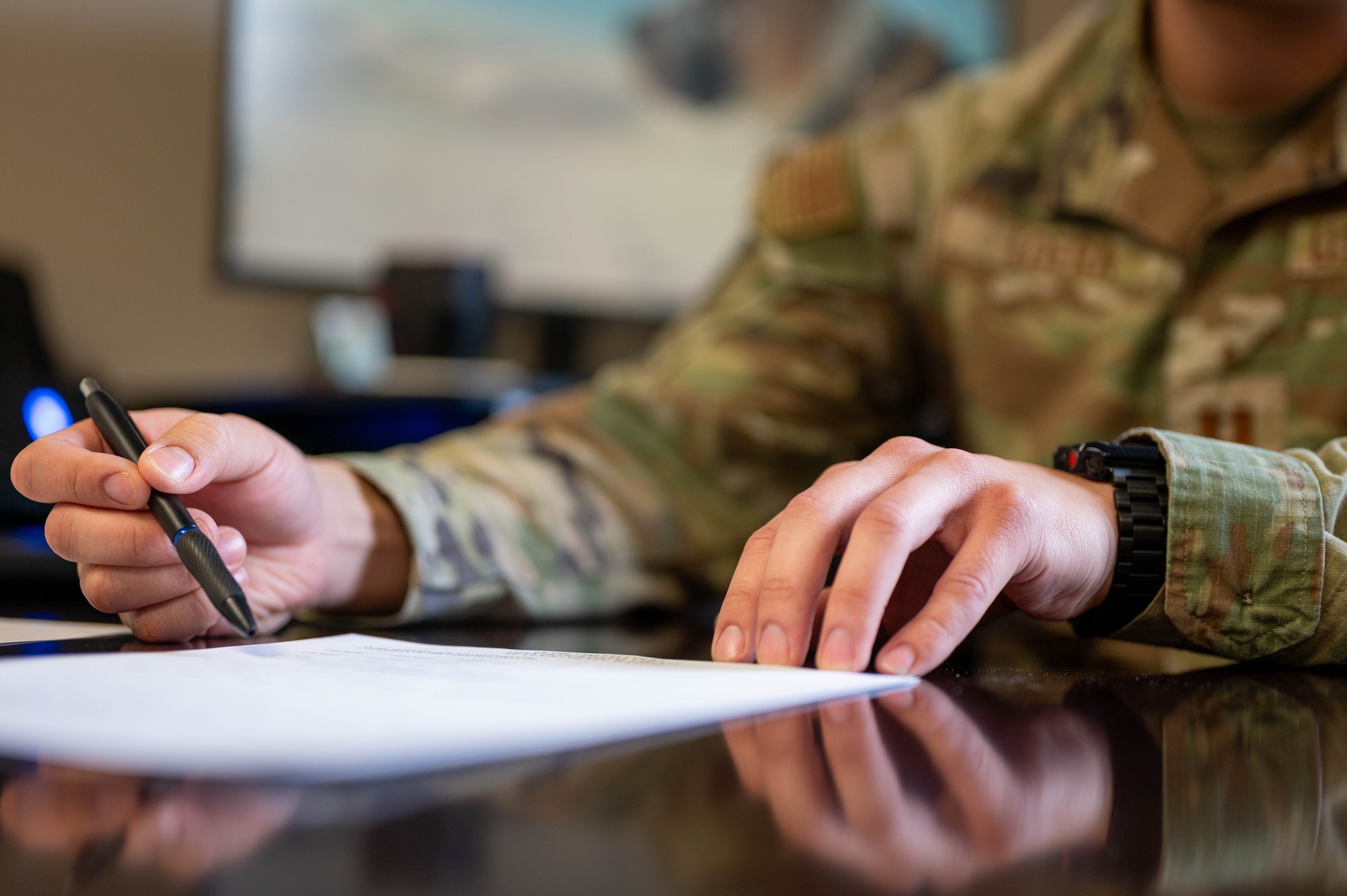 Airman points out information on a document