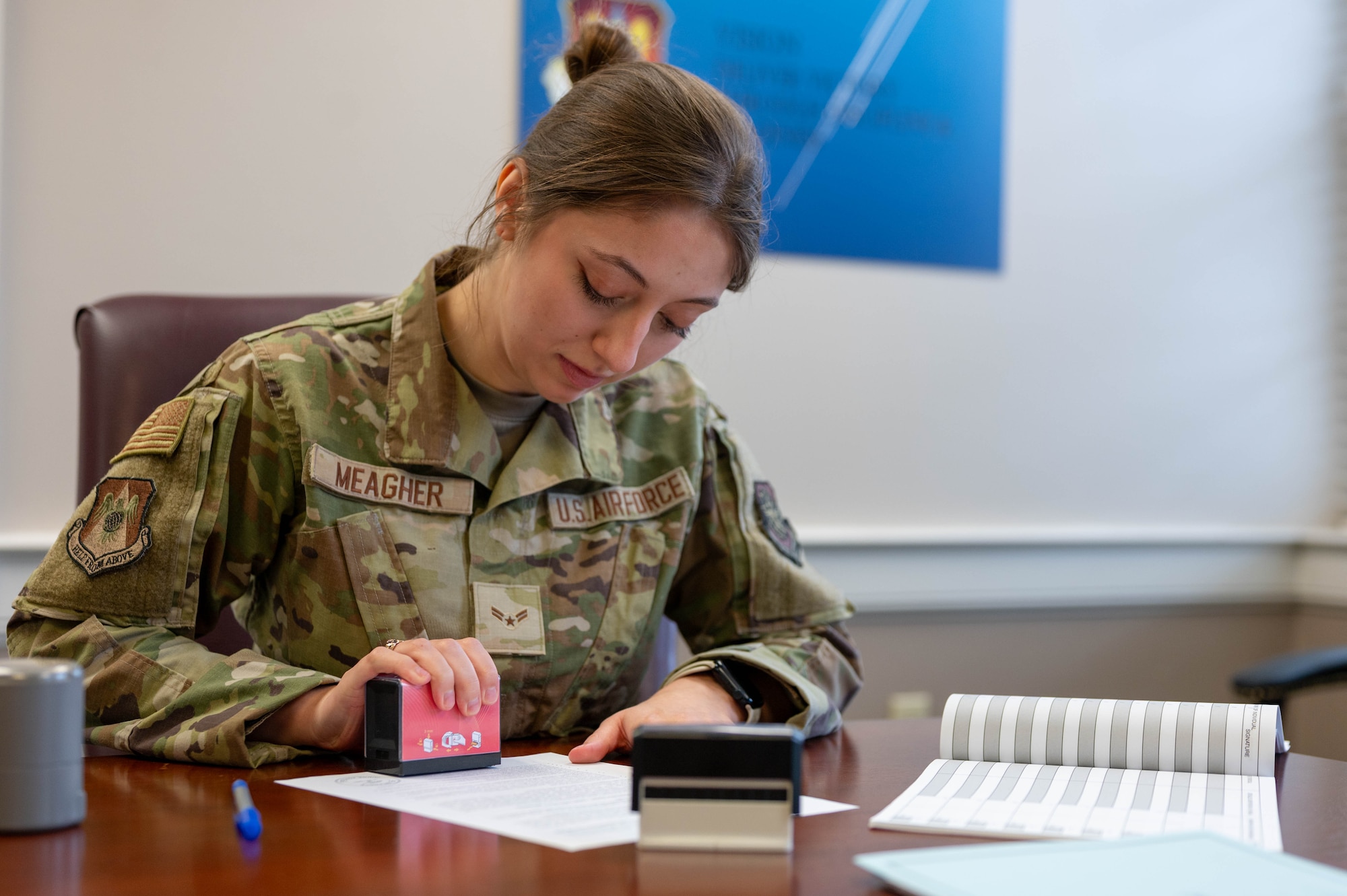 JA Airman stamping a document