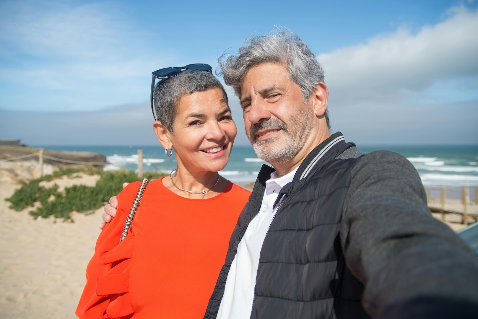 A man and woman standing on a beach
