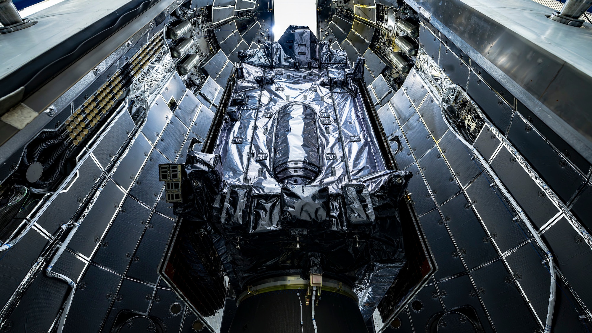 SpaceX teams encapsulated the U.S. Space Force's GPS III Space Vehicle 9 satellite into Falcon 9’s rocket fairing. This next GPS mission launch is planned for 25 January 2026. (Courtesy Photo)