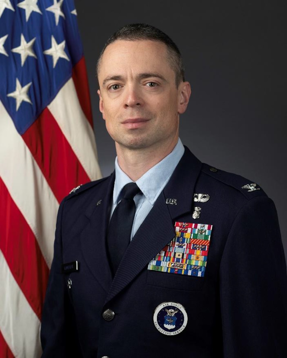 Person poses for picture in front of US flag