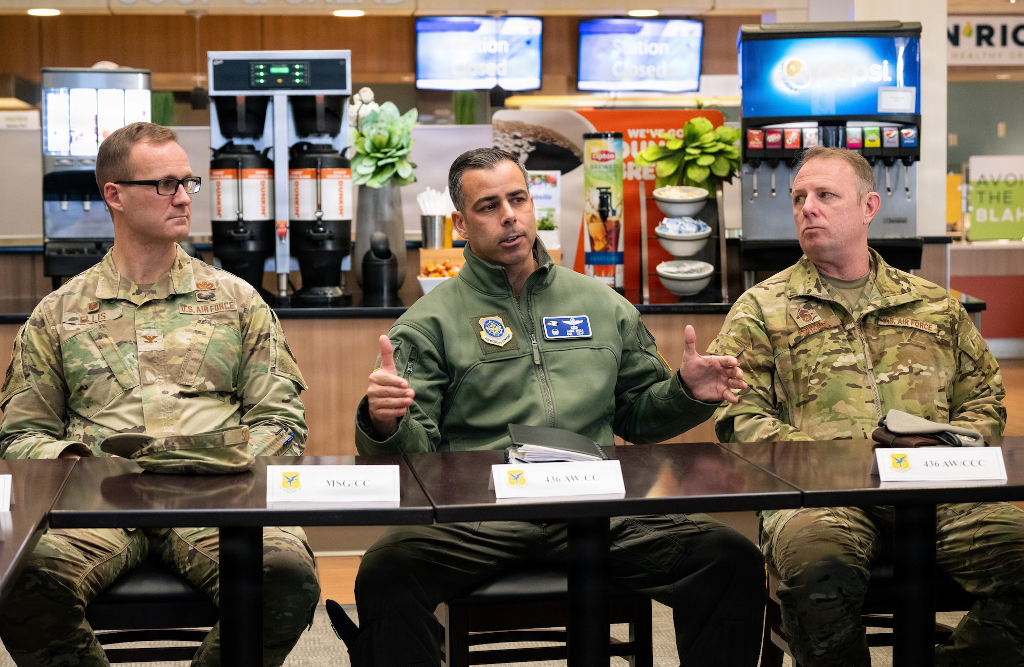 U.S. Air Force Col. Brian Ellis, left, 436th Mission Support Group commander, and Chief Master Sgt. Elijah Edwards, right, 436th AW command chief, listen to Col. Jamil Musa, middle, 436th Airlift Wing commander, during a formal meeting for the Hennessy Food Services awards at Dover Air Force Base, Delaware, Jan. 22, 2026.