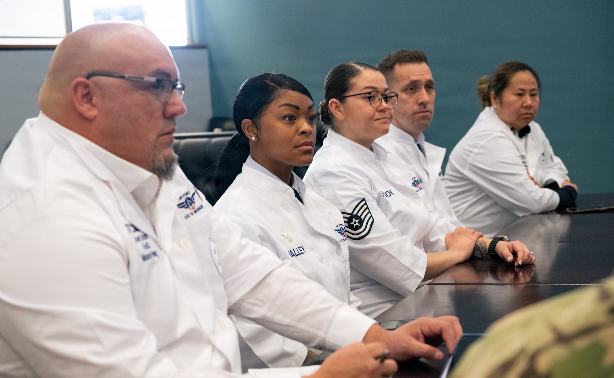 Critics from the Hennessy Food Services awards listen to briefs about the mission that the 436th Force Support Squadron contribute to during the formal portion of their inspection on Dover Air Force Base, Delaware, Jan. 22, 2026.