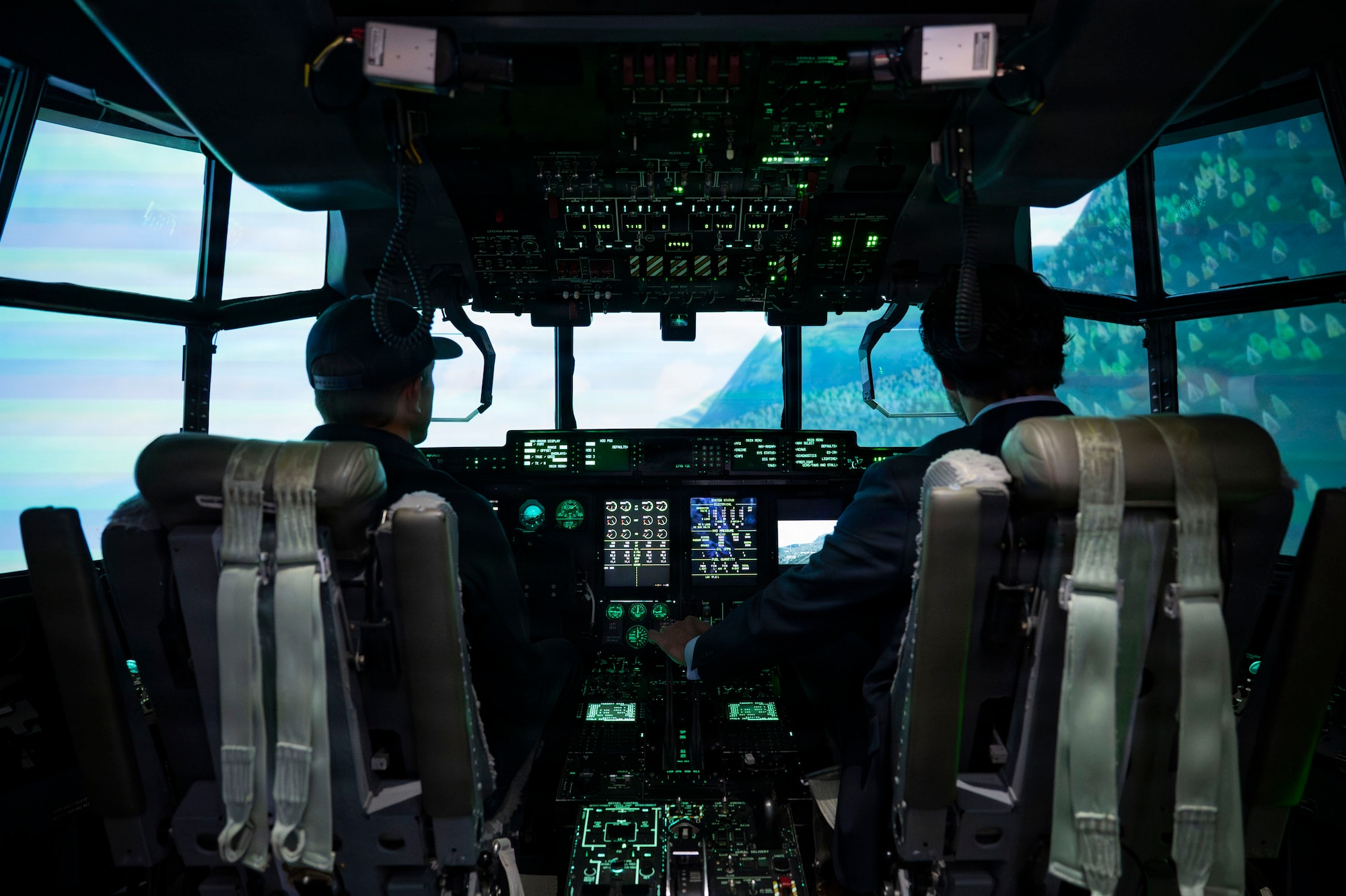 Under Secretary of the Air Force Matt Lohmeier and William Gugelman, HC-130J simulator instructor pilot, fly in an HC-130J Combat King II aircraft simulator at Davis-Monthan Air Force Base, Arizona, Jan. 21, 2026. The session allowed Lohmeier to operate the aircraft from takeoff through landing, highlighting DM’s realistic training environment for mission-ready aircrew. (U.S. Air Force photo by Airman 1st Class Samantha Melecio)
