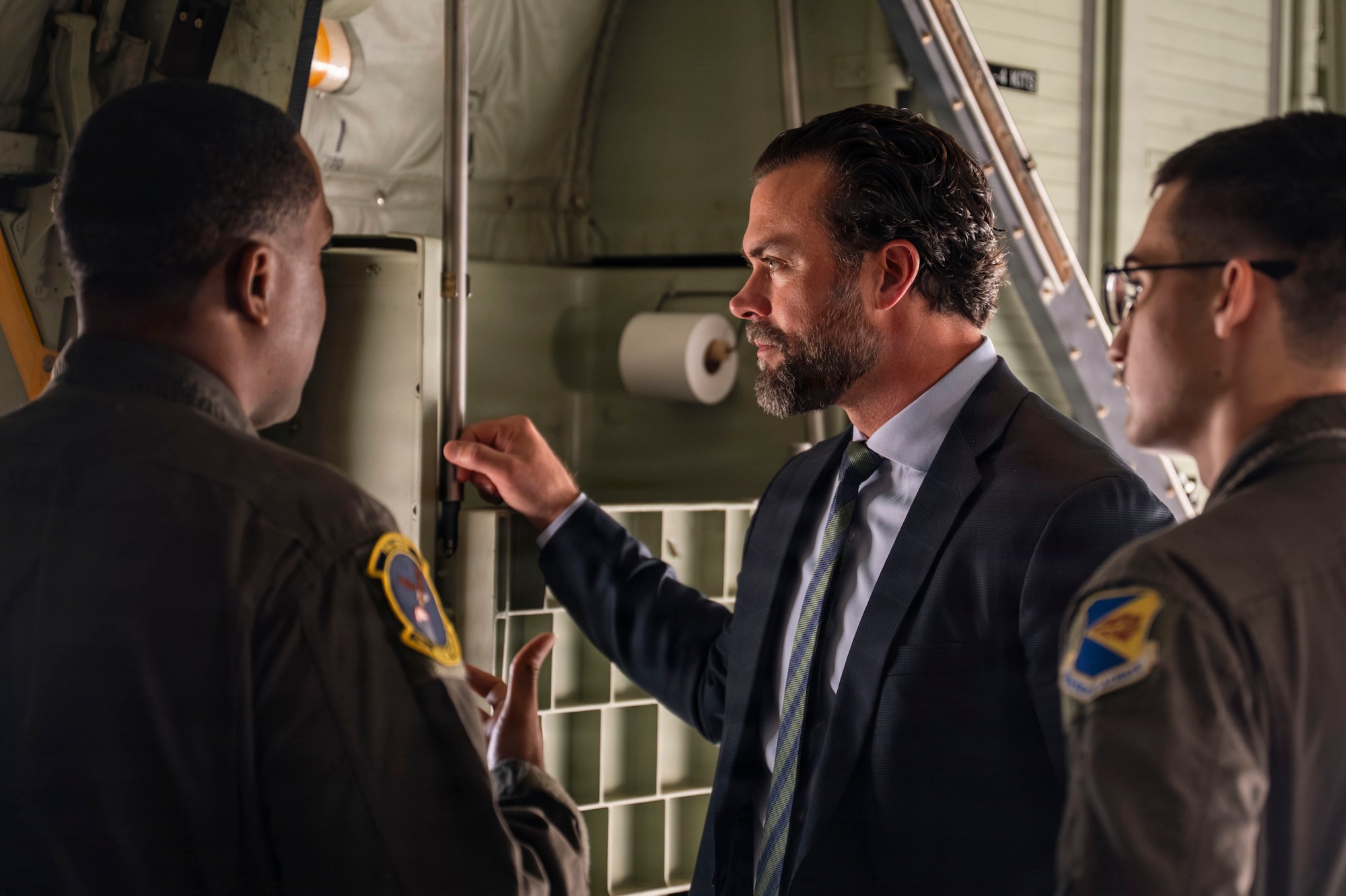 Under Secretary of the Air Force Matt Lohmeier, U.S. Air Force Staff Sgt. Gregory Jackson and Senior Airman Ian Cosper, assigned to the 79th Rescue Squadron, discuss the different parts of an HC-130J Combat King II aircraft at Davis-Monthan Air Force Base, Arizona, Jan. 21, 2026. Jackson and Cosper explained to Lohmeier how each component contributes to the HC-130J’s role in rescue and combat operations. (U.S. Air Force photo by Airman 1st Class Samantha Melecio)