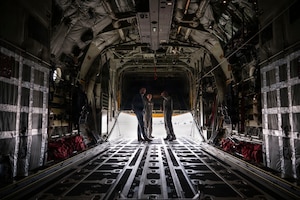 Under Secretary of the Air Force Matt Lohmeier is briefed by U.S. Air Force Staff Sgt. Gregory Jackson and Senior Airman Ian Cosper, assigned to the 79th Rescue Squadron, on the HC-130J Combat King II aircraft and its mission capabilities at Davis-Monthan Air Force Base, Arizona, Jan. 21, 2026. Lohmeier toured the aircraft and learned how its different components contribute to operational effectiveness. (U.S. Air Force photo by Airman 1st Class Samantha Melecio)