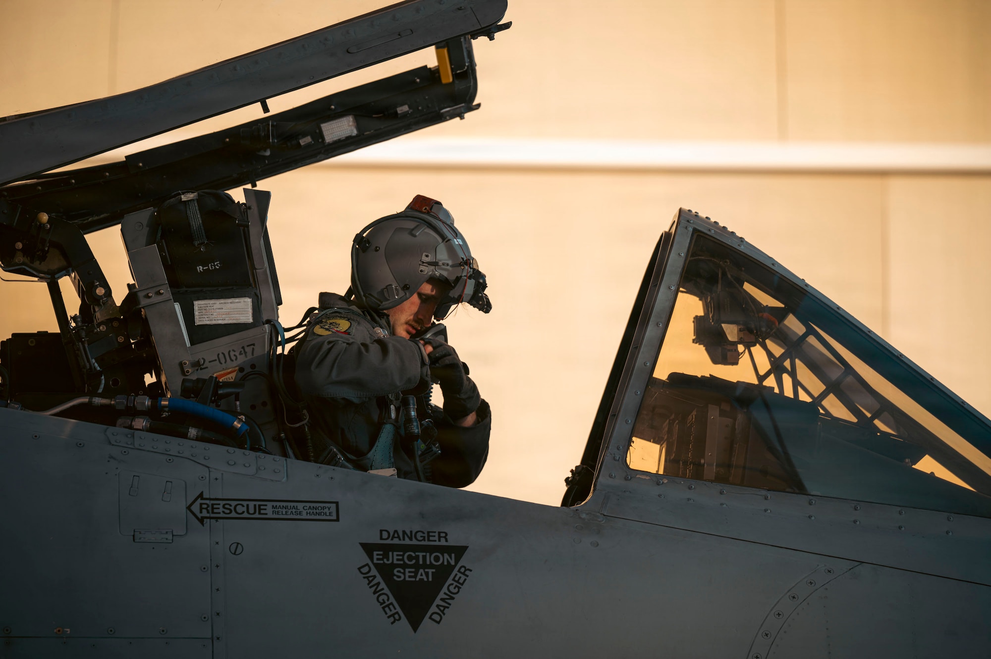 U.S. Air Force 1st Lt. Brayden Mathis, 357th Fighter Squadron A-10C Thunderbolt II aircraft student pilot, performs preflight checks on his equipment before taking flight at Davis-Monthan Air Force Base, Arizona, Dec. 16, 2025. Mathis performed the final student night flight in an A-10C Thunderbolt II aircraft. (U.S. Air Force photo by Airman 1st Class Samantha Melecio)