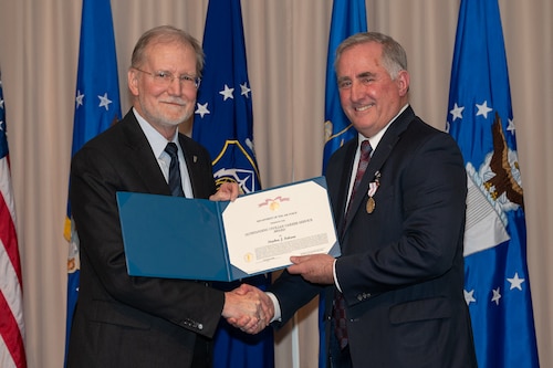 Steven Wert, a Senior Executive Service member and deputy assistant secretary for Acquisition Integration, presents Stephen Falcone, Electronic Systems director of engineering, with the Outstanding Civilian Career Service Award at a retirement ceremony at Hanscom Air Force Base, Mass., Jan. 15.