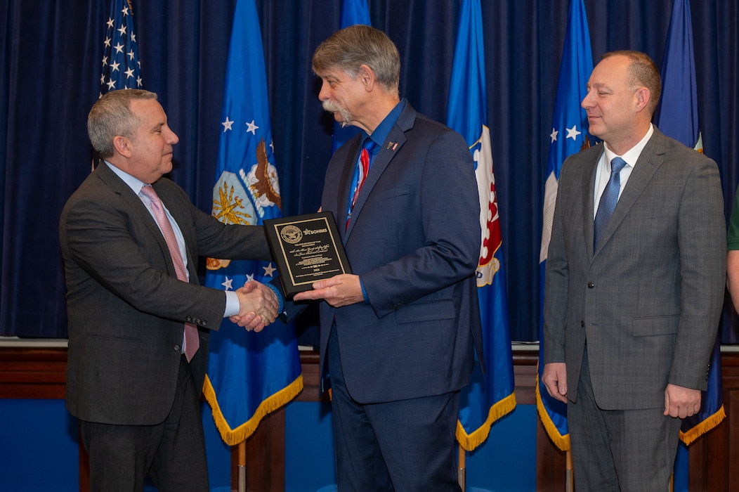 Image of person presenting award.