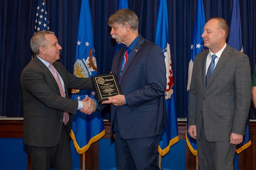 Image of person presenting award.