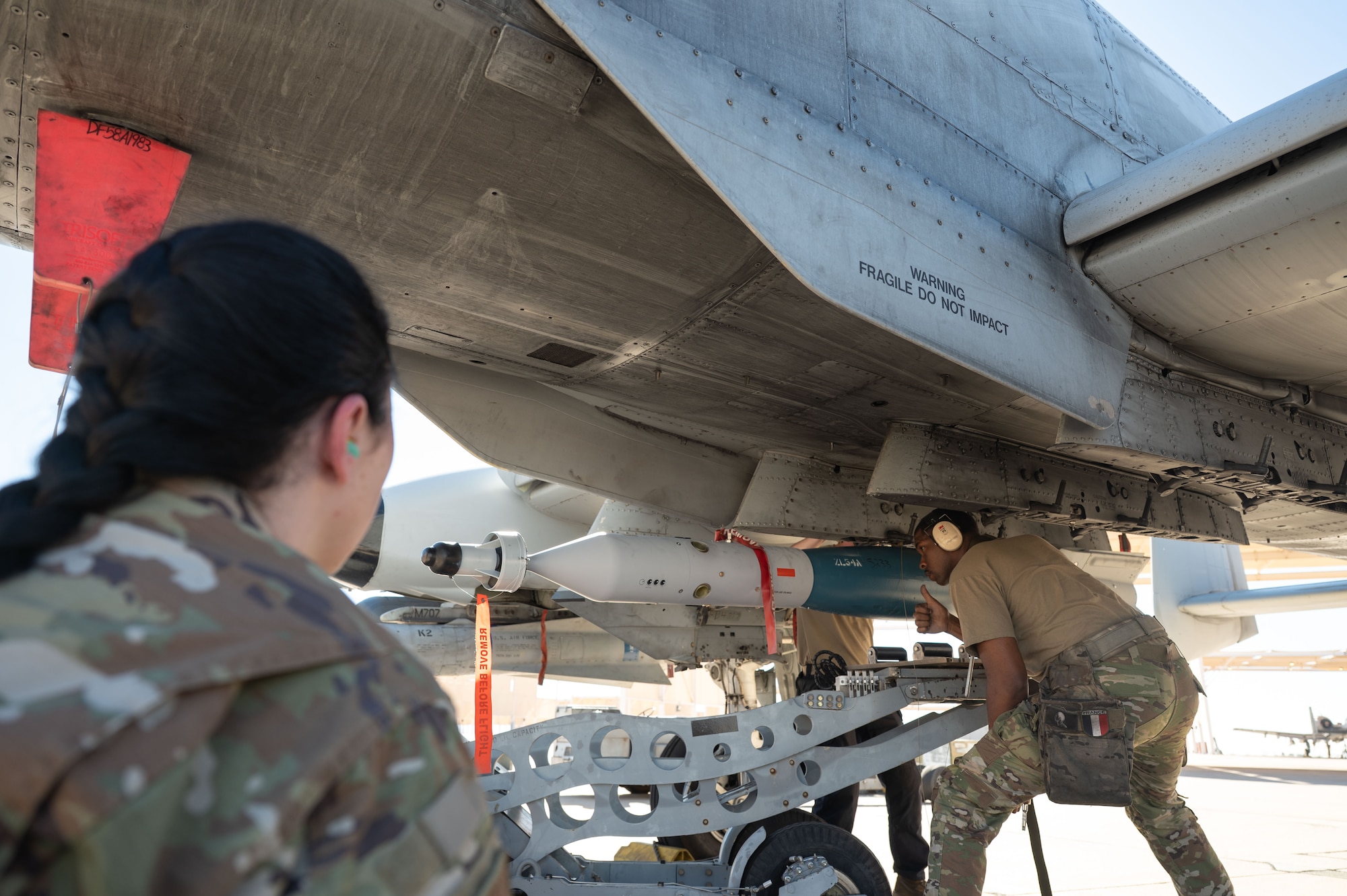 A U.S. Air Force Airman is graded during the 2025 Load Competition of the Year at Davis-Monthan Air Force Base, Arizona, Jan. 16, 2026. Four weapons load crews displayed their mission readiness by competing head-to-head to load missiles and bombs onto an A-10C Thunderbolt II as quickly as possible while maintaining strict safety standards and adhering to USAF instructions. (U.S. Air Force photo by Airman 1st Class Jaden Kidd)