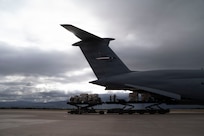 Cargo is offloaded from a military airplane