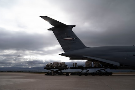 Cargo is offloaded from a military airplane