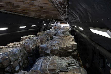 Cargo sits in the cargo hold of a military airplane