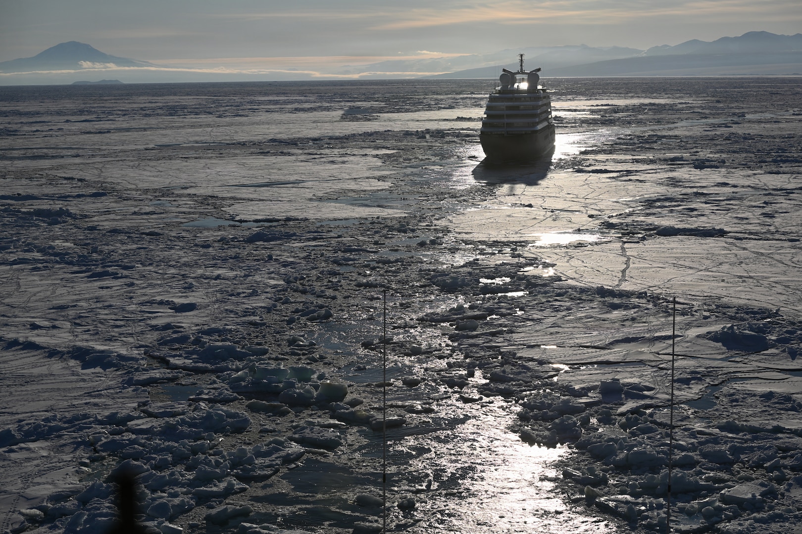 USCGC Polar Star (WAGB 10) escorts an Australian-owned cruise ship out of pack ice in the Ross Sea after the vessel requested assistance amid Operation Deep Freeze 2026, Jan. 17, 2026. Pacific Air Forces operates on a 24-hour basis to provide the U.S. National Science Foundation complete joint operational and logistic support for Operation Deep Freeze. (U.S. Coast Guard photo by Petty Officer 2nd Class Christopher Bokum)