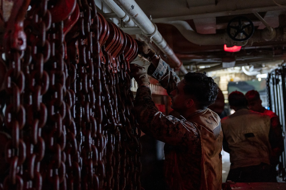 U.S. Marine Corps Lance Cpl. Alberto Aguilera, a combat cargo Marine assigned to Wasp-class amphibious assault ship USS Boxer (LHD 4), retrieves loading chains during ship to shore operations in the Pacific Ocean, Jan. 21, 2026.