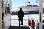 USCGC Polar Star (WAGB 10) crew members observe an Australian-owned cruise ship that requested assistance, Jan. 17, 2026, during support to the U.S. National Science Foundation’s Operation Deep Freeze 2026. The U.S. National Science Foundation is the U.S. Government agency that promotes the progress of science, funds and manages the Antarctic Program. (U.S. Coast Guard photo by Petty Officer 2nd Class Christopher Bokum)