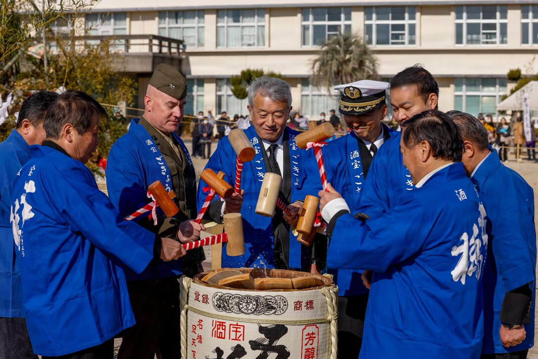 Community leaders, strike a sake barrel's top with wooden mallets at a traditional Tondo festival at Kawashimo Elementary School, Iwakuni, Japan, Jan. 12, 2026. The annual festival marks the Japanese New Year and Coming of Age Day, bringing together community leaders and residents to pray for good health, prosperity, and strong ties between the local community and U.S. residents of Marine Corps Air Station Iwakuni. (U.S. Marine Corps photo by Lance Cpl. Isaac De Leon)