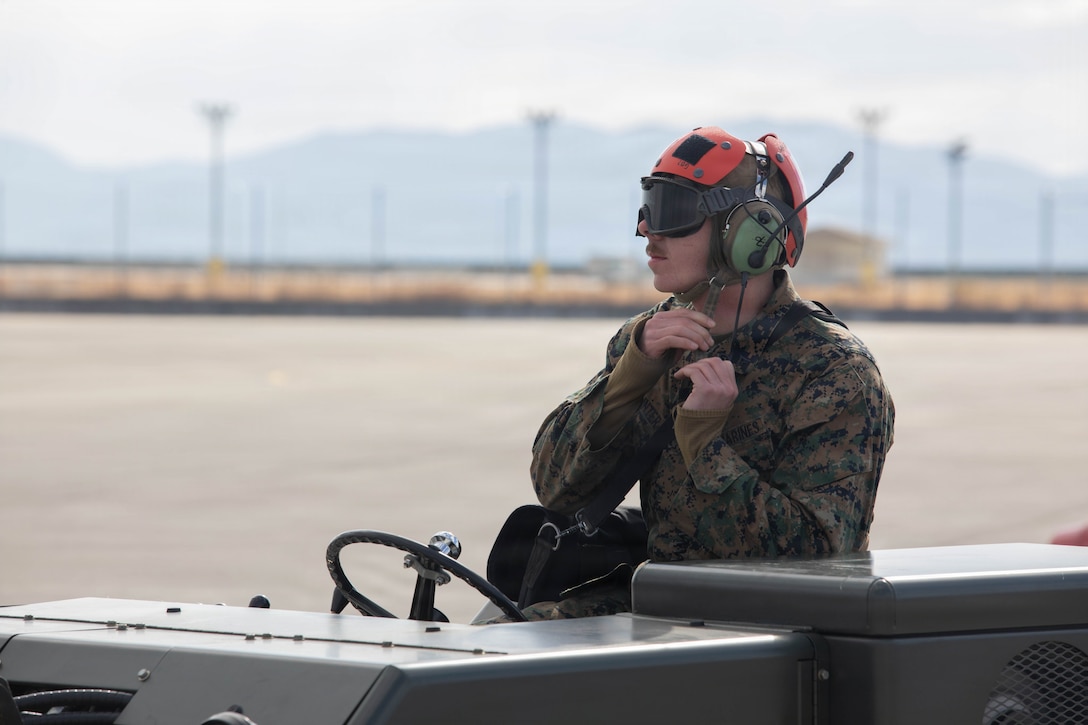 U.S. Marine Corps Lance Cpl. Gavin Hunter, an aircraft ordnance technician with Marine Fighter Attack Squadron (VMFA) 232, Marine Aircraft Group 12, 1st Marine Aircraft Wing, straps his helmet before performing onloading and offloading operations at Marine Corps Air Station Iwakuni, Japan, Jan. 8, 2026. The practical application of both refueling and ordnance loading enables units to improve their overall efficiency and operational readiness. (U.S. Marine Corps photo by Lance Cpl. Siwan Lewis)