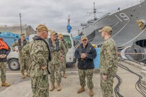 Lt. Cmdr. Jesse Crider, port operations officer for Commander, Fleet Activities Yokosuka (CFAY), speaks with Vice Adm. Scott Gray, Commander, Navy Installations Command (CNIC), during a tour of CFAY’s harbor.