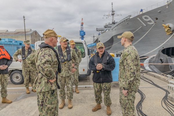 Lt. Cmdr. Jesse Crider, port operations officer for Commander, Fleet Activities Yokosuka (CFAY), speaks with Vice Adm. Scott Gray, Commander, Navy Installations Command (CNIC), during a tour of CFAY’s harbor.