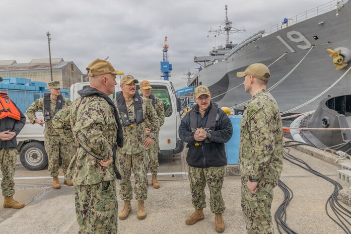 Lt. Cmdr. Jesse Crider, port operations officer for Commander, Fleet Activities Yokosuka (CFAY), speaks with Vice Adm. Scott Gray, Commander, Navy Installations Command (CNIC), during a tour of CFAY’s harbor.