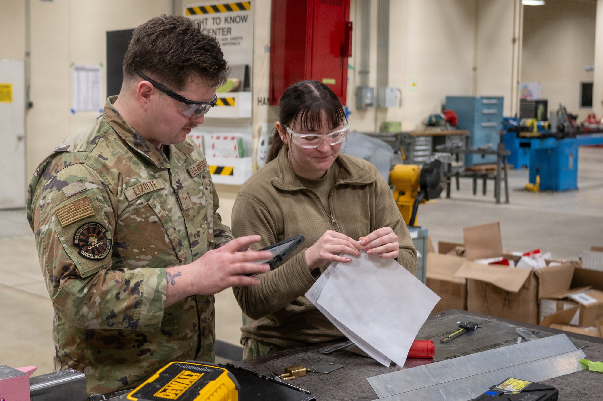 U.S. Air Force Airman 1st Class Jeremy Lizotte, left, 35th Maintenance Group aircraft structural maintenance journeyman, and Senior Airman Malela Peralta, 35th Maintenance Group aircraft structural maintenance journeyman, analyze structural blueprints at Misawa Air Base