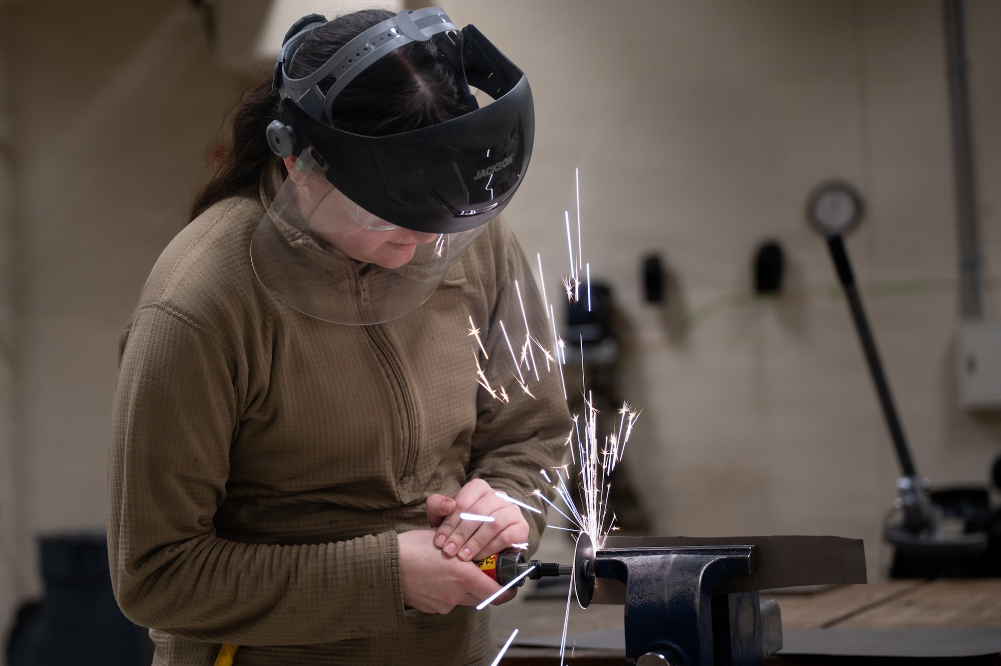U.S. Air Force Senior Airman Malela Peralta, 35th Maintenance Group aircraft structural maintenance journeyman, saws a steel rod at Misawa Air Base