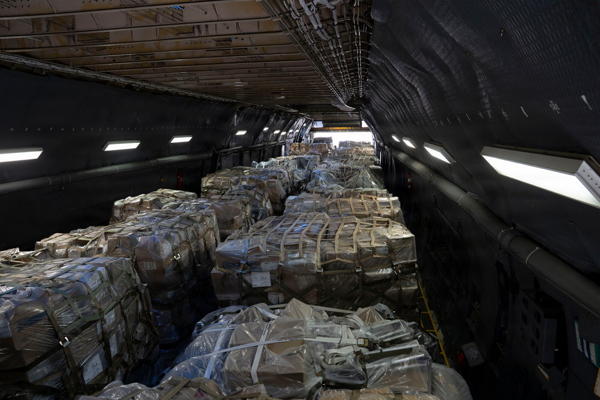 Cargo sits in the cargo hold of a military airplane