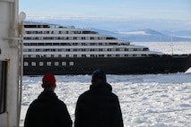 USCGC Polar Star (WAGB 10) crew members view an Australian-owned cruise ship stuck in ice along the Ross Sea, Jan. 17, 2026, while supporting the National Science Foundation in Antarctica. The U.S. National Science Foundation is the U.S. Government agency that promotes the progress of science, funds and manages the Antarctic Program. (U.S. Coast Guard photo by Petty Officer 2nd Class Christopher Bokum)