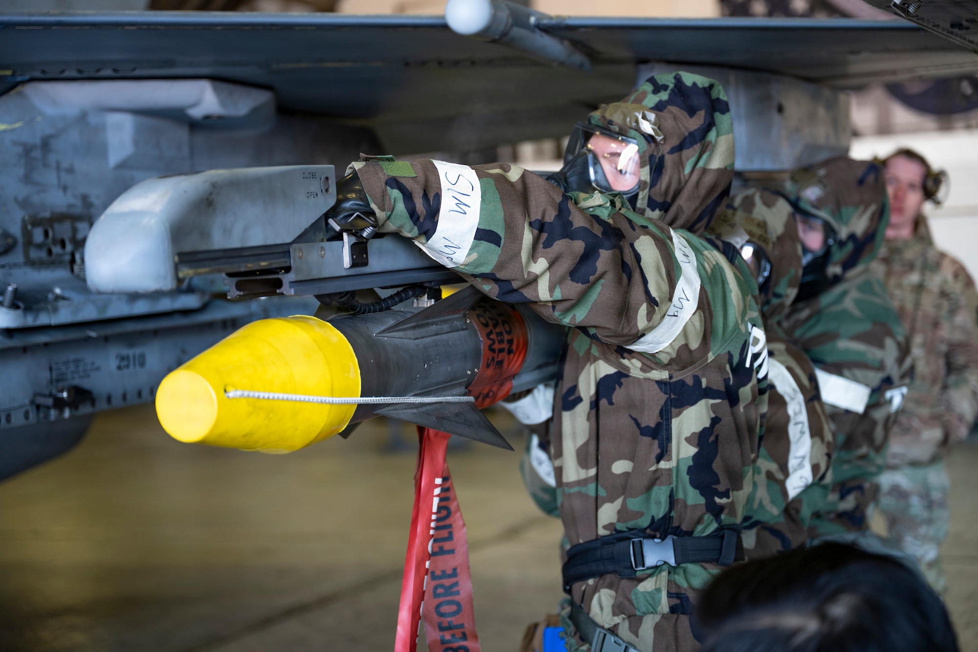 U.S. Air Force Airmen assigned to the 35th Fighter Generation Squadron load munitions onto an F-16 Fighting Falcon during the Annual Bomb Build and Loading Competition at Osan Air Base, Republic of Korea, Jan. 22, 2026.