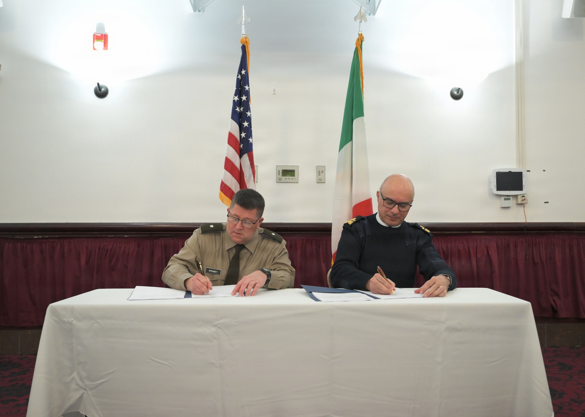 U.S. Army National Guard Brig. Gen. Chris A. McKinney, deputy director J5 United States European Command, and Rear Admiral Marco Montoneri, deputy head of Strategic Direction and Military Cooperation of the Italian Defense General Staff, sign meeting minutes to conclude a meeting.