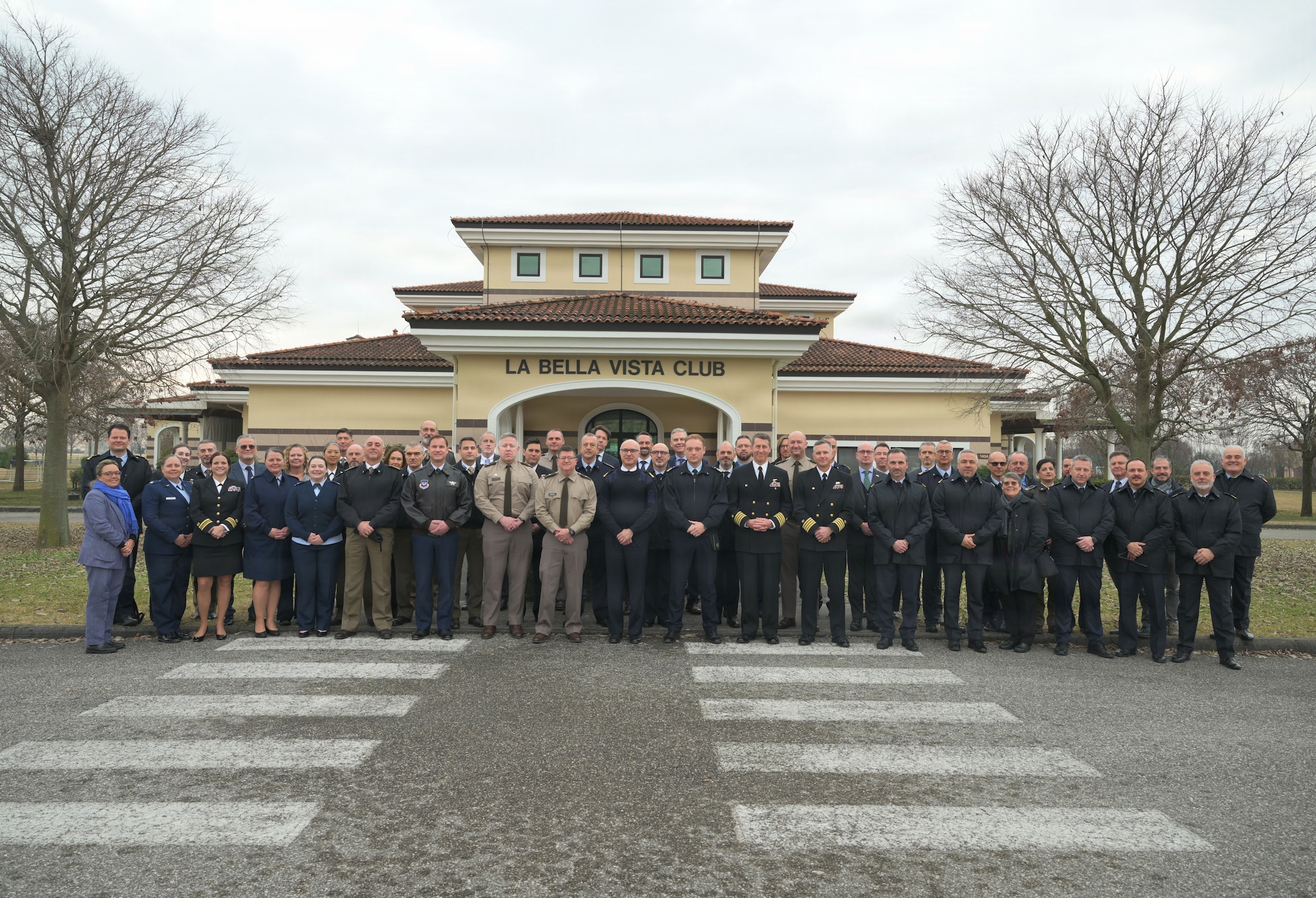 A group of high ranking officials stand together for a group photo.