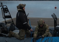 U.S. Navy explosive ordnance disposal technicians from EODMU 8 lay a line on a rigid-hull inflatable boat before conducting ordnance disposal operations as part of exercise Freezing Winds 25 in Upinniemi, Finland, Nov. 25, 2025.