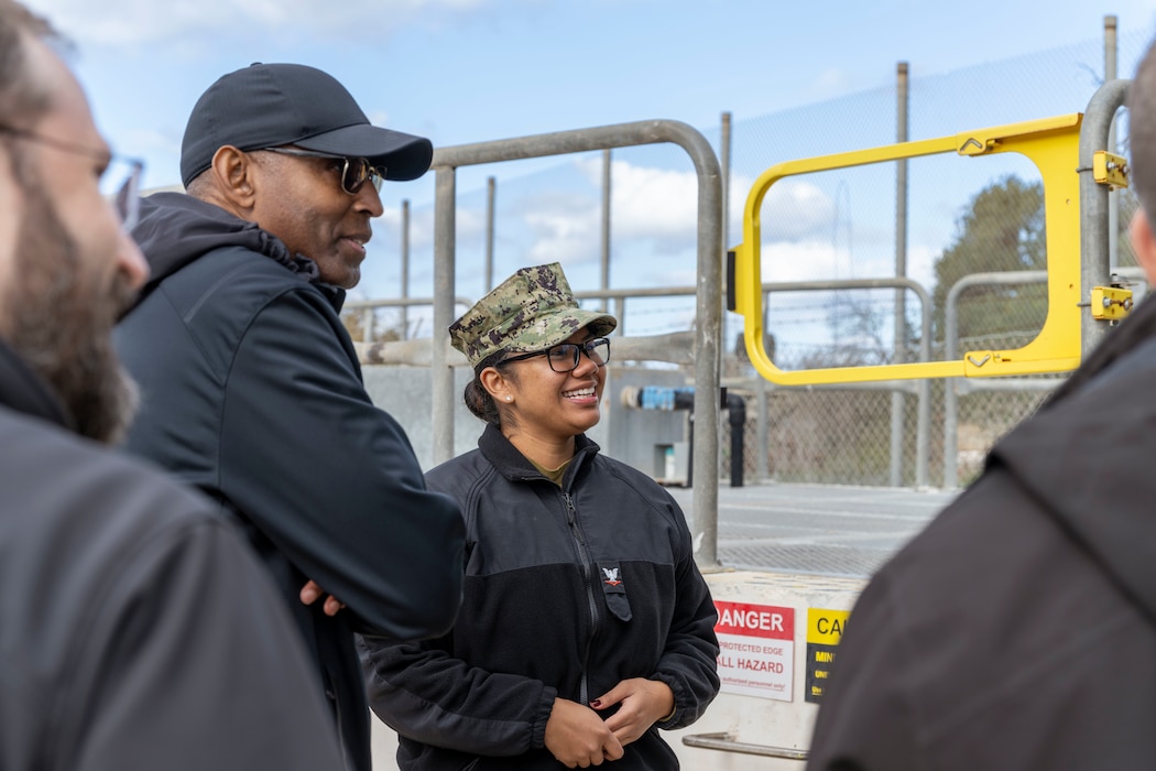 Utilitiesman 3rd Class Dennisse CruzParada, assigned to Naval Facilities Engineering Systems Command, Europe, Africa, Central, Public Works Department Souda Bay, discusses Naval Support Activity (NSA) Souda Bay’s water treatment capabilities with Navy Installations Command Executive Director Timothy Bridges during a scheduled site visit onboard NSA Souda Bay, Jan. 14, 2026.