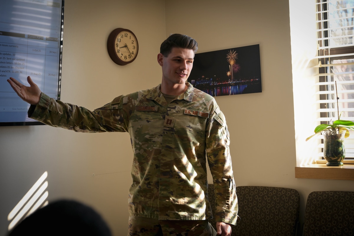 A man in uniform speaks with his team members.