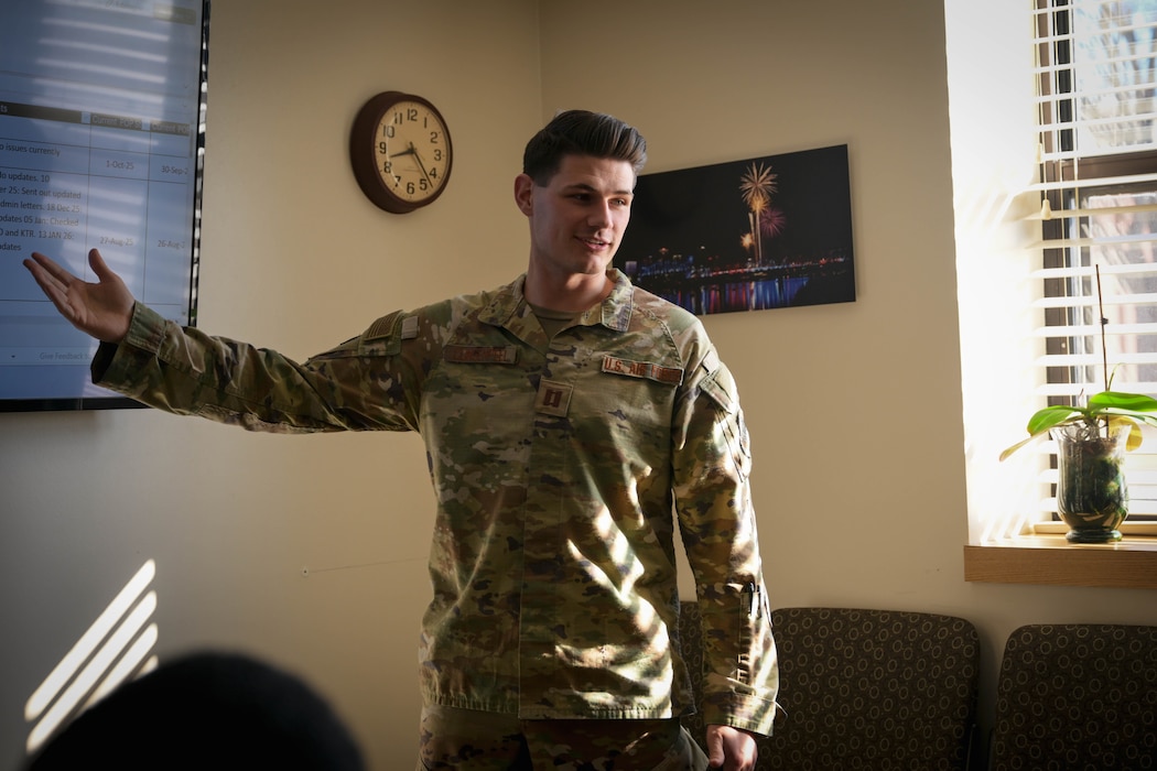 A man in uniform speaks with his team members.