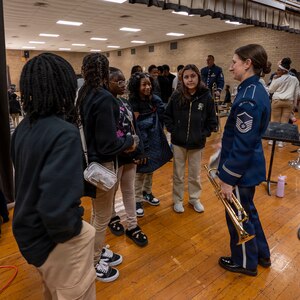 U.S. Air Force Master Sgt. Kristin Cazenave, trumpet player and noncommissioned officer in charge of priority events with The U.S. Air Force Band, speaks with Gwynn Park Middle School band students in Brandywine, Md., Jan. 15, 2026. Kazanave, one of the founding members of District Brass, helped create the program from her experience in the Air Force Regional Bands in Omaha, Neb., and Colorado Springs, Colo. (U.S. Air Force photo by Staff Sgt. Jordan Powell)